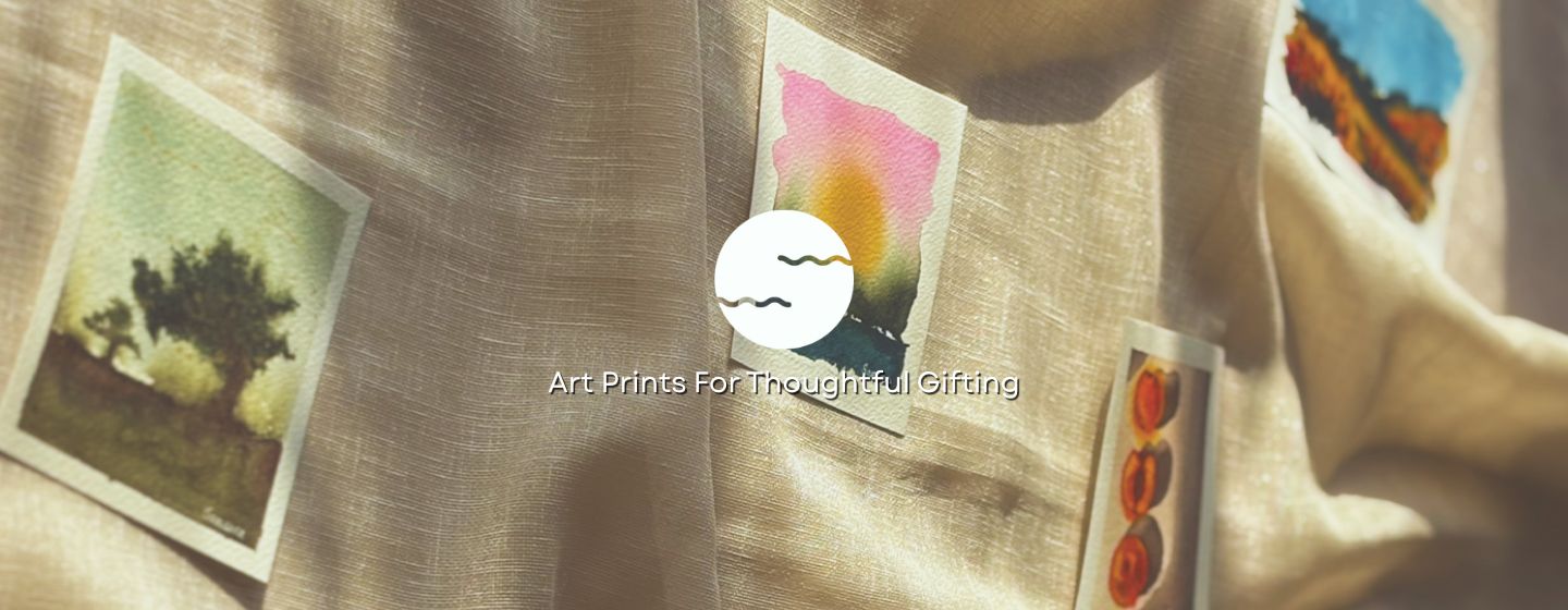 Art prints of trees and abstract designs on a textured fabric background.
