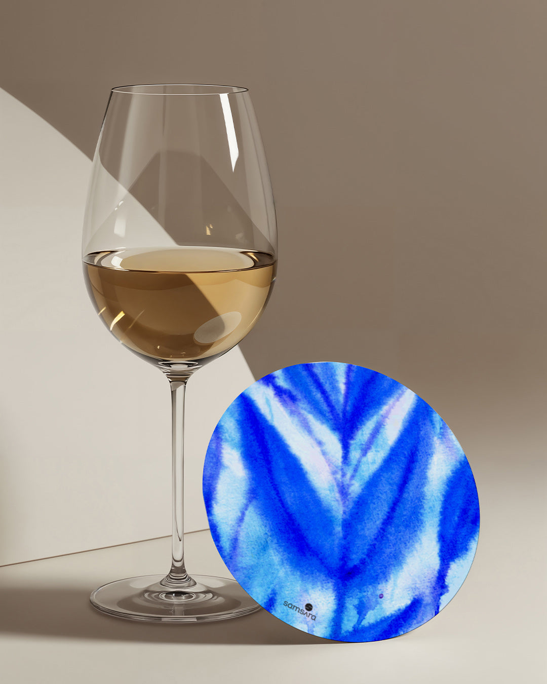 Blue shibori pattern coasters in modern living room setting - indigo watercolor home decor