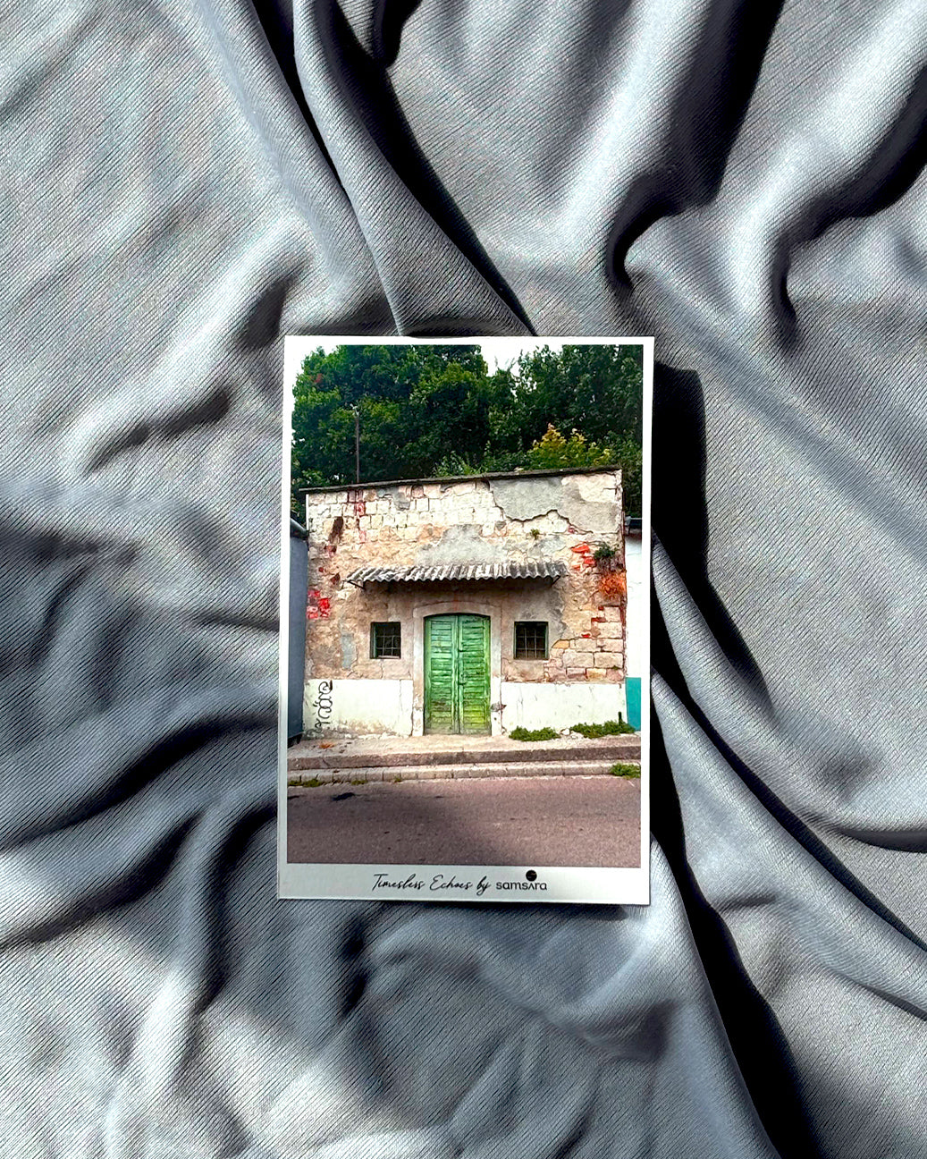 Vintage-style postcard with a house with green door on textured gray background