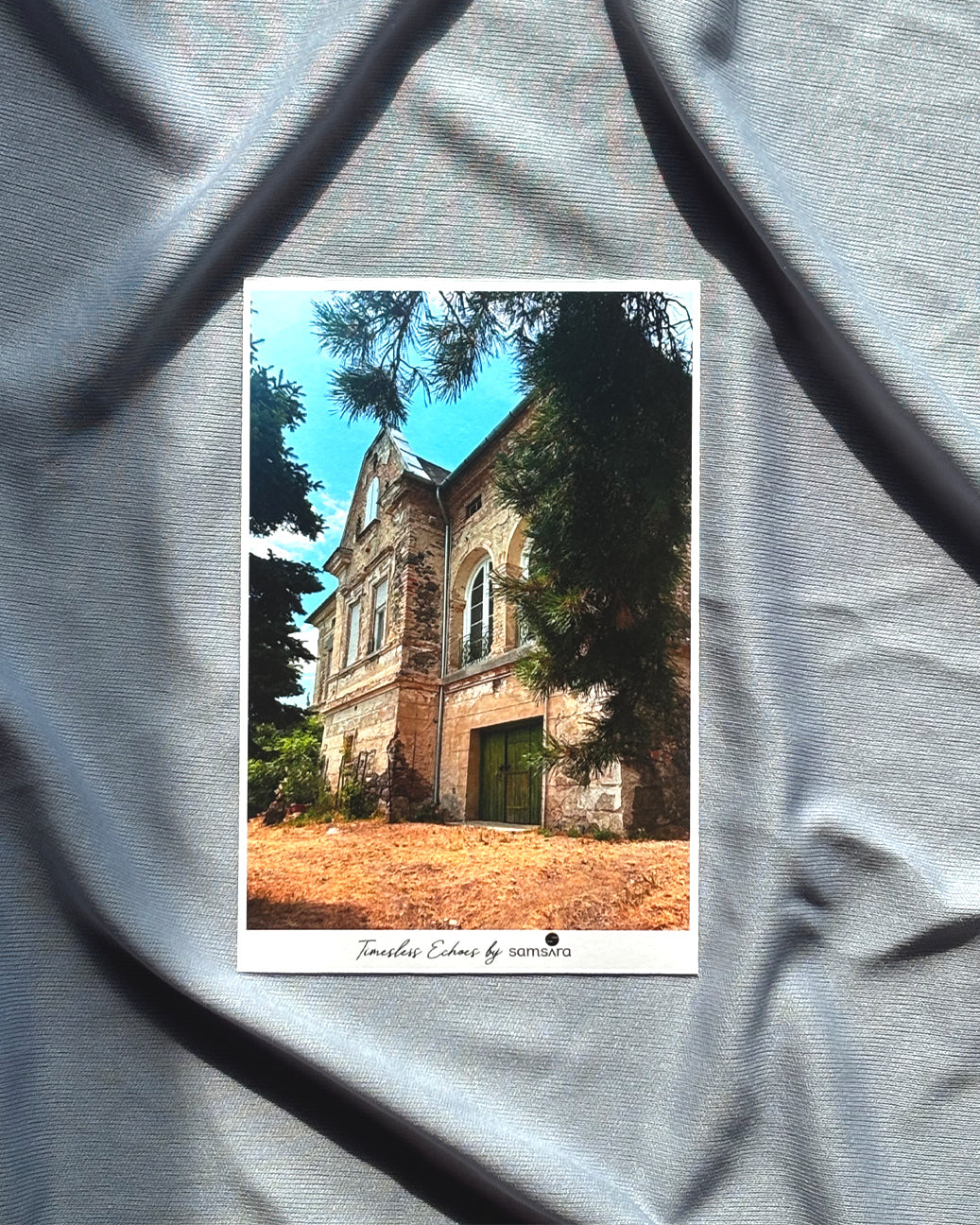 Picture of a building with trees on a gray fabric background