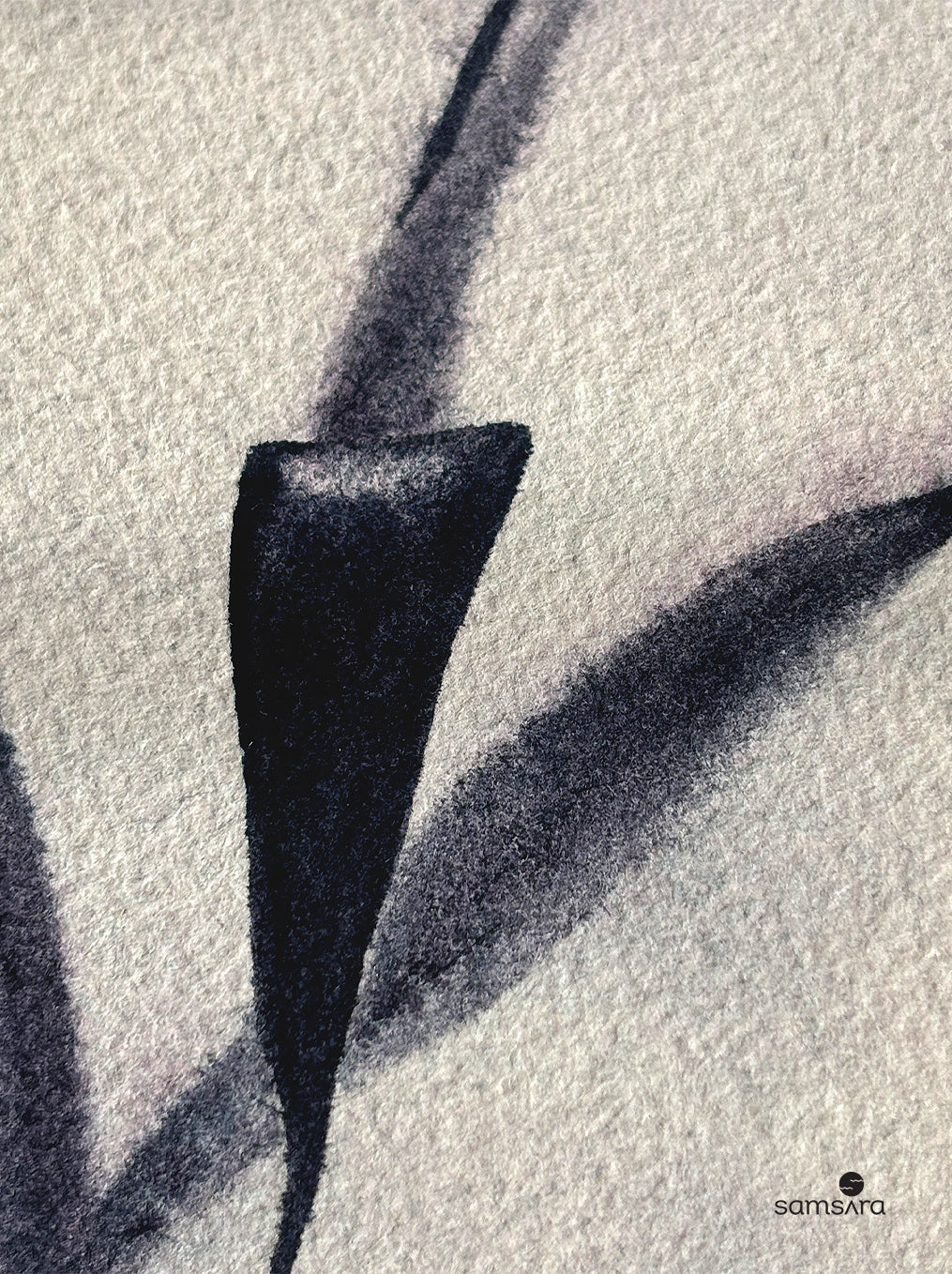 Black abstract leaf-like shape on textured white surface with 'samsara' branding.