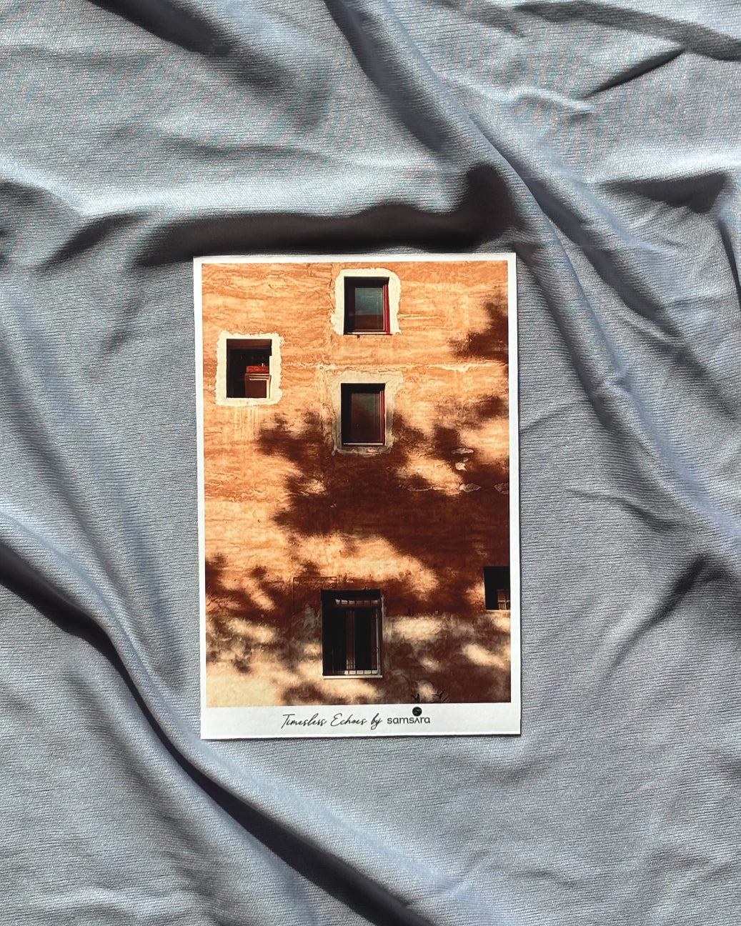 Postcard with a brick wall design on crumpled gray fabric