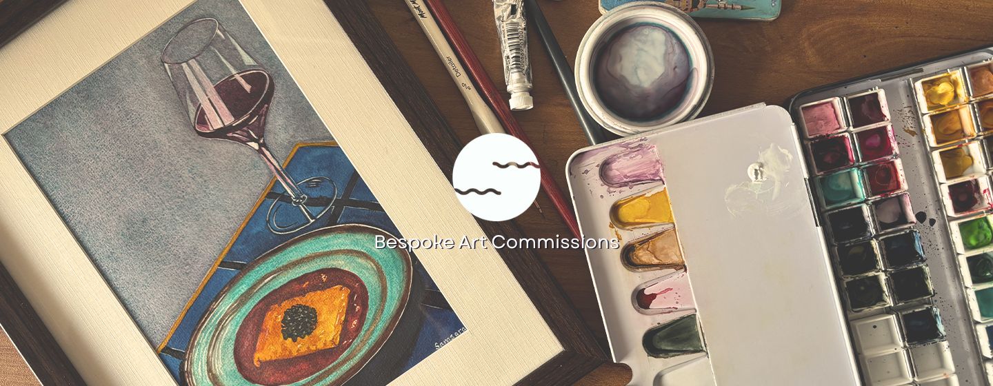 Artistic setup with watercolor paints and a painting of a wine glass.