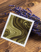 A Giclée mini art print titled Earthline, featuring swirling patterns of green and brown, presented on a neutral background.