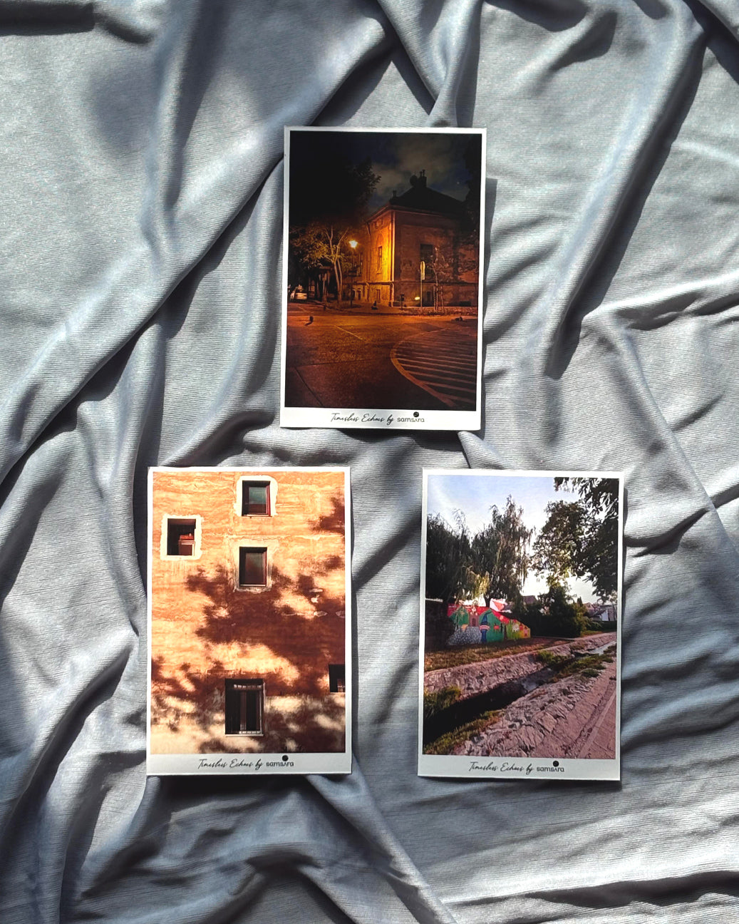 Three photo prints on a textured gray surface