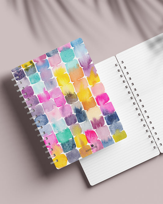Candies colorful notebook open displaying ruled pages and vibrant cover - artistic spiral journal