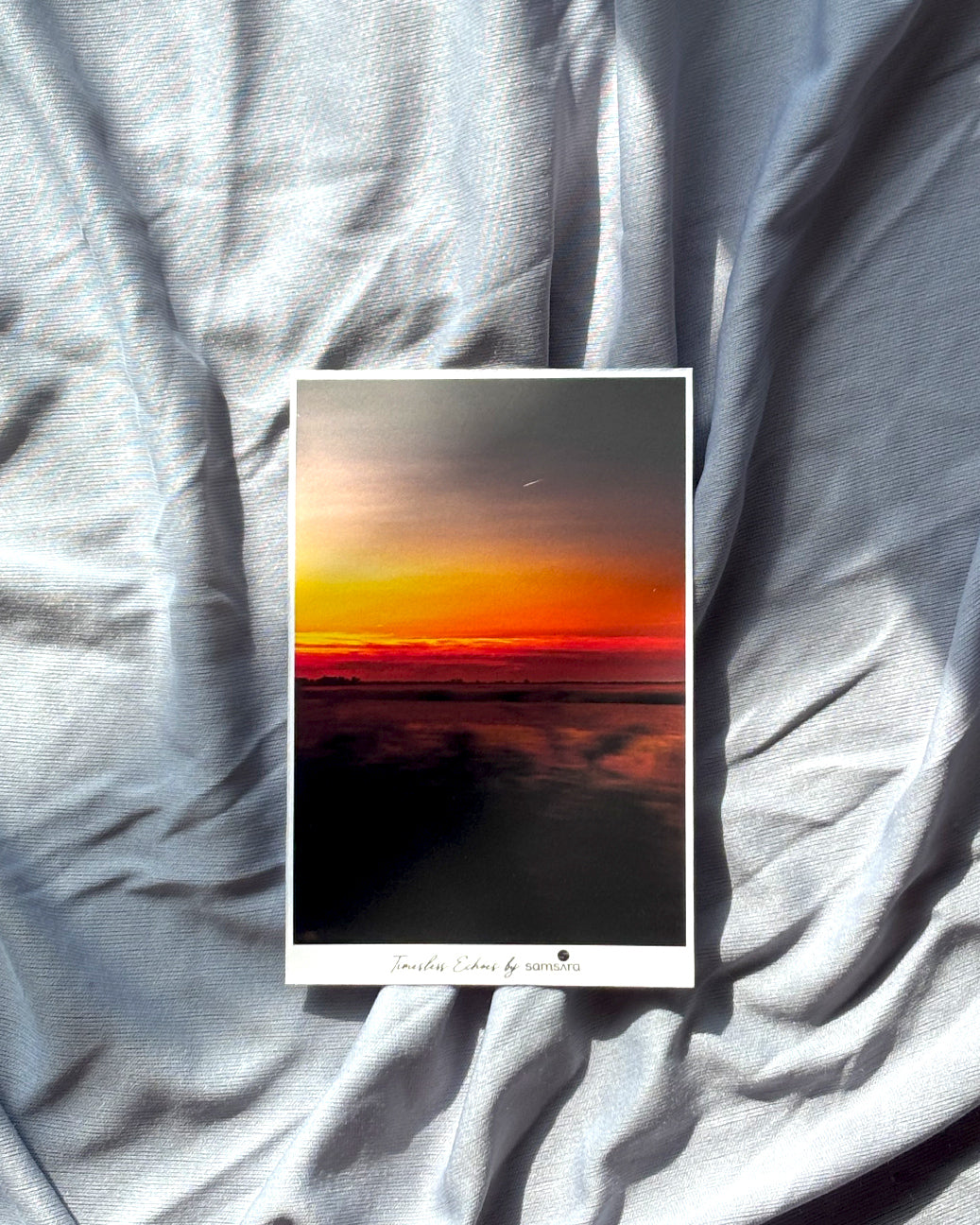 Mini nature sunset art print displayed on a grey surface