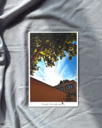 Poster of a tree and building on a gray fabric background