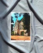 Picture of a building with trees on a gray fabric background