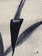 Black abstract leaf-like shape on textured white surface with 'samsara' branding.
